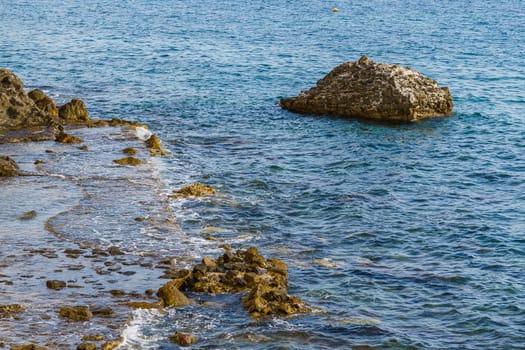 Sea shore. Stones and surf, summer day