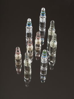 medical ampoules for injections on a dark background with reflection