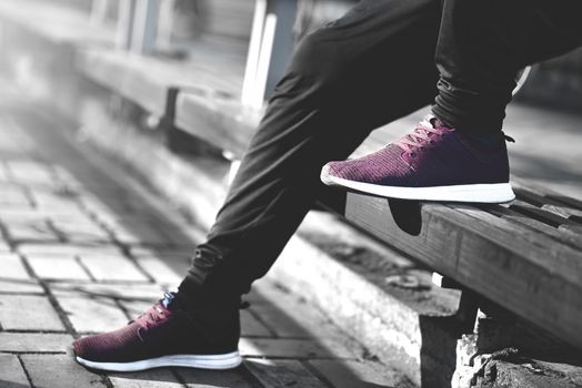 Man in sneakers walks down the street on a sunny day