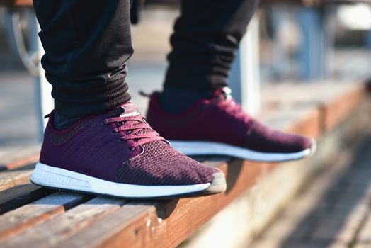 Man in sneakers walks down the street on a sunny day