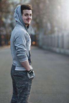 Sporty young man working out at early morning with background sunrise