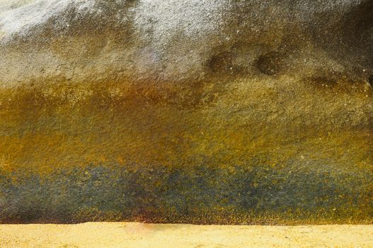Background stone texture. Yellow gold rock wall. 