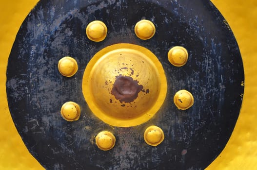 A close-up shot of a large Thai gong, which is an ancient Thai musical instrument.
