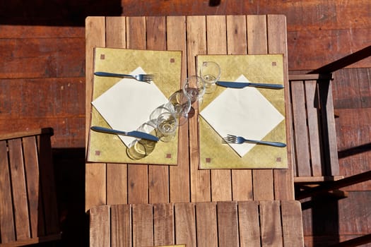 Empty, wooden tables in the restaurant waiting for customers, view from above.