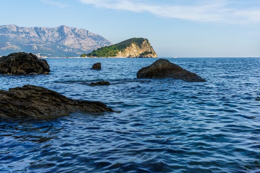 Sea shore. Stones and surf, summer sunset