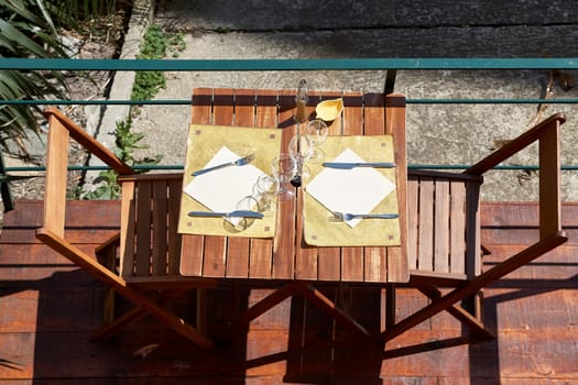 Empty, wooden tables in the restaurant waiting for customers, view from above.