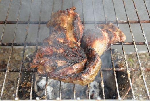 Pork roasted on a charcoal grill, grilled until cooked.