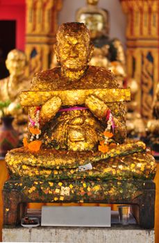 Thai Buddha statue Is covered with gold leaf, Reverend Grandfather Tim.