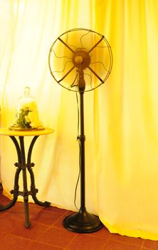 Black ancient Thai fans There is a yellow curtain in the background.