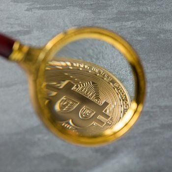 Viewing and the increase in bitcoin through a magnifying glass. electronic money