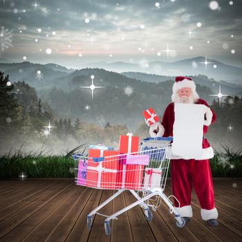 Santa delivering gifts from cart against mountain range beyond wooden floor