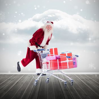 Santa pushing shopping cart against clouds in a room