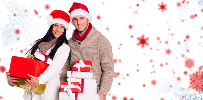 Young couple with many christmas presents against snowflake pattern
