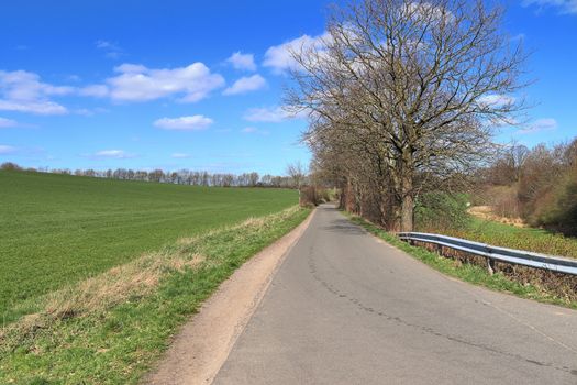 Beautiful view on countryside roads with fields and trees in northern europe.