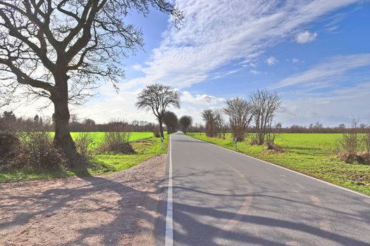 Beautiful view on countryside roads with fields and trees in northern europe.