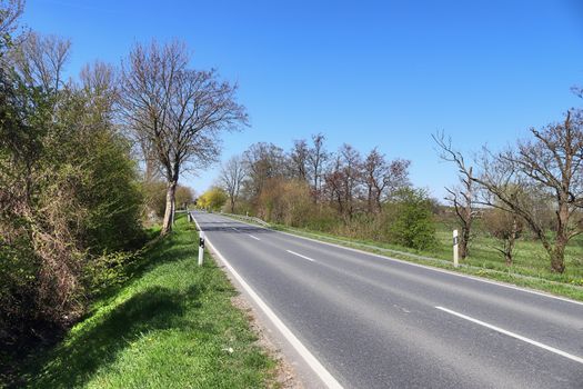 Beautiful view on countryside roads with fields and trees in northern europe.