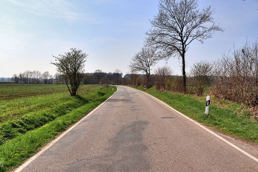 Beautiful view on countryside roads with fields and trees in northern europe.