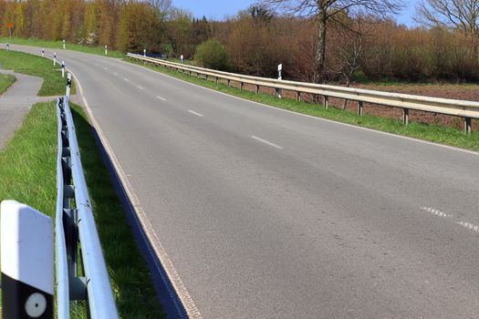 Beautiful view on countryside roads with fields and trees in northern europe.