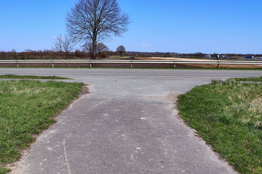 Beautiful view on countryside roads with fields and trees in northern europe.