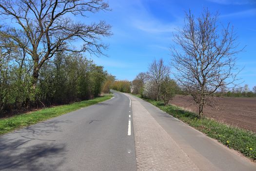 Beautiful view on countryside roads with fields and trees in northern europe.