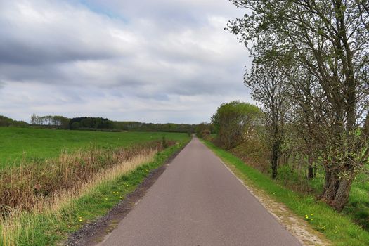 Beautiful view on countryside roads with fields and trees in northern europe.