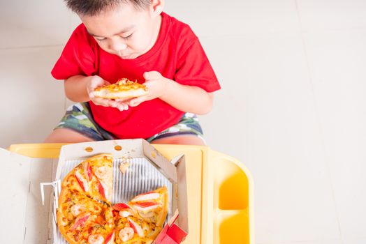Hot Homemade, Vegetarian fast Italian food, Top view of Cute Little Child enjoying eating Delivery Pizza pepperoni, cheese many slices deliciously in a cardboard box at home with copy space for text