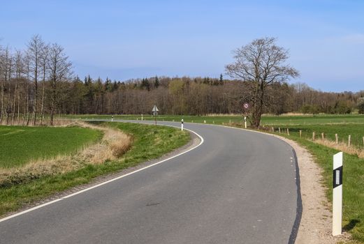 Beautiful view on countryside roads with fields and trees in northern europe.