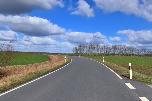 Beautiful view on countryside roads with fields and trees in northern europe.