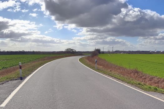 Beautiful view on countryside roads with fields and trees in northern europe.