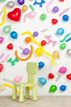 small highchair on a background with balloons