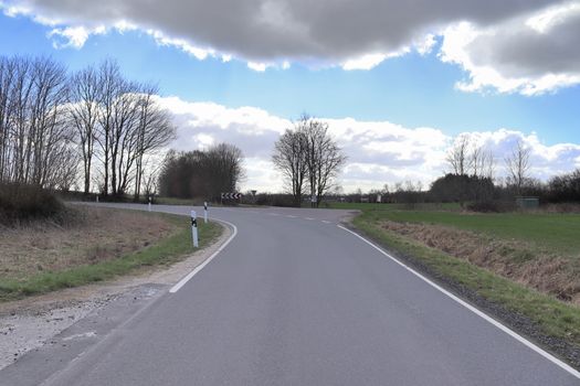 Beautiful view on countryside roads with fields and trees in northern europe.