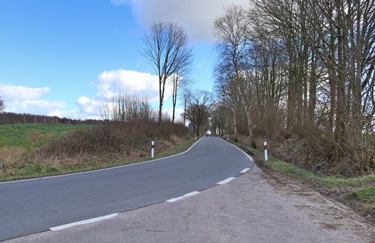 Beautiful view on countryside roads with fields and trees in northern europe.