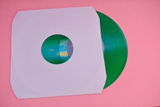 Green vinyl record against colorful background