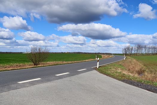 Beautiful view on countryside roads with fields and trees in northern europe.