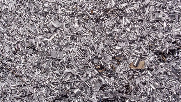 Metal background. Colored shavings. Wallpaper or screensaver of colored metallic chips.Abstract color background of metal shavings. Processing of ferrous and non-ferrous metals in a factory or plant. 