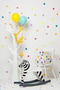 homemade wooden toy zebra swing and a tree with balloons