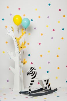 homemade wooden toy zebra swing and a tree with balloons