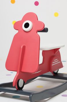 homemade red children's toy motorcycle on a white background