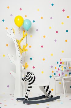 homemade wooden toy zebra swing and a tree with balloons