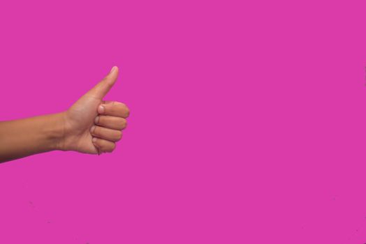 Thumbs up sign against colorful background