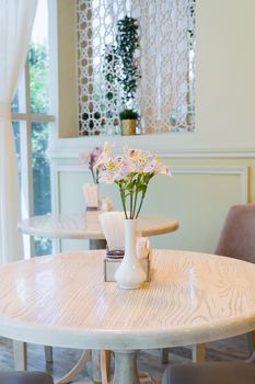 modern restaurant interior with windows and flowers. cafe room illuminated by sunlight