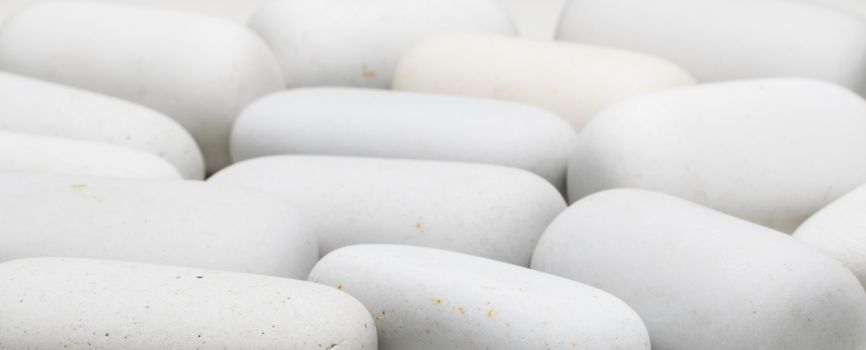 background of white smooth stones of elongated shape