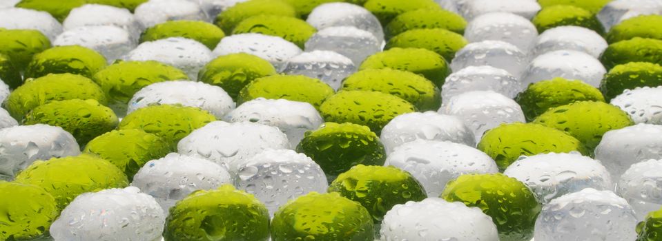 artificial round stones with water drop of green and white color. imitation pebbles