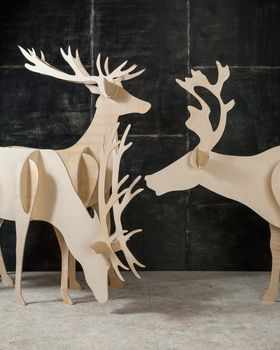 New Year's and Christmas decoration deer made of plywood and wood on a dark background