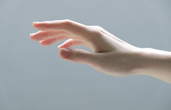 Young woman hand reaching out for touch something