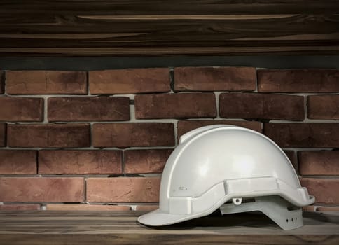 White safety helmet on wood floor