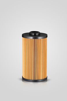 automotive filter cylindrical shape of orange color on a white background with reflection