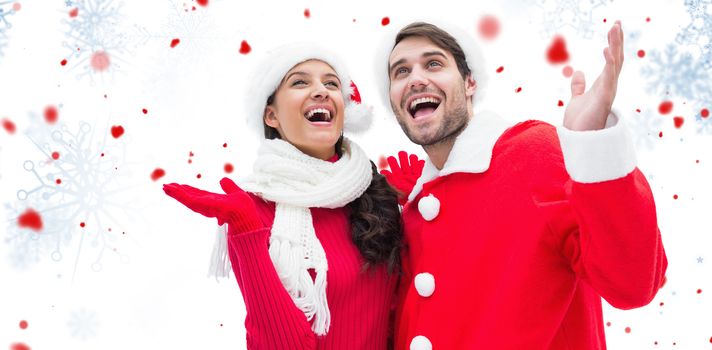 Festive young couple against snowflake pattern