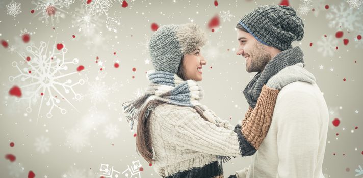 Young winter couple against snowflake pattern