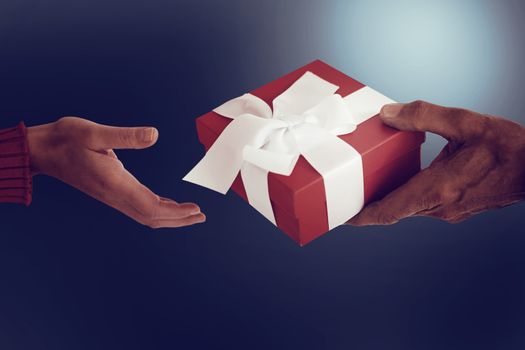 Couple holding gift on dark background